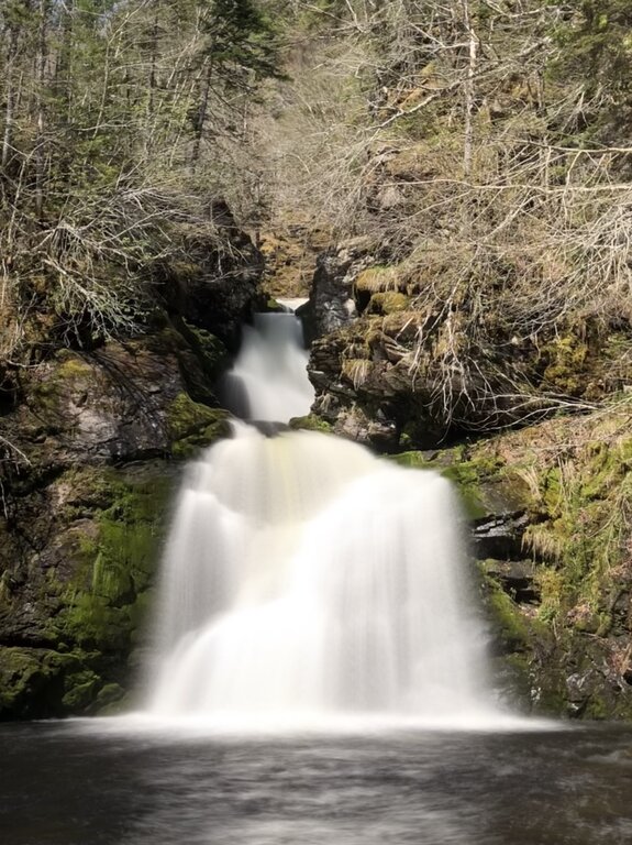gairloch mountain falls in cape breton. the water flows over the falls in a fan shape.