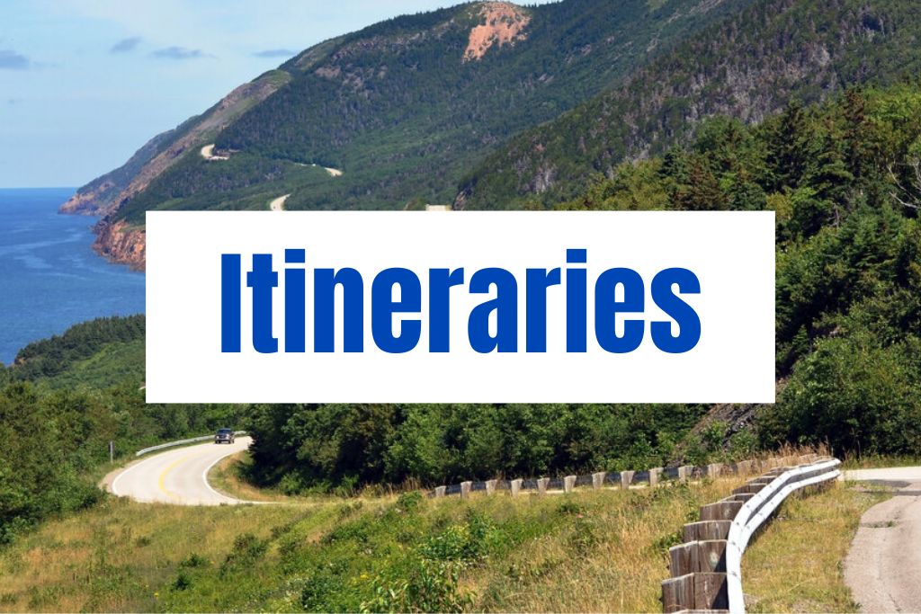 "Itineraries" appears in large blue text over a scenic coastal road winding through green hills beside the ocean. The image highlights planning a road trip along Nova Scotia’s rugged coastline.