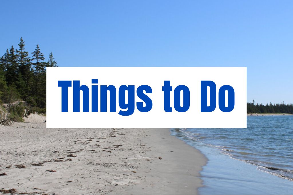 "Things to Do" appears in large blue text over a quiet sandy beach with gentle waves and trees along the shore. The image represents outdoor activities and coastal experiences in Nova Scotia.