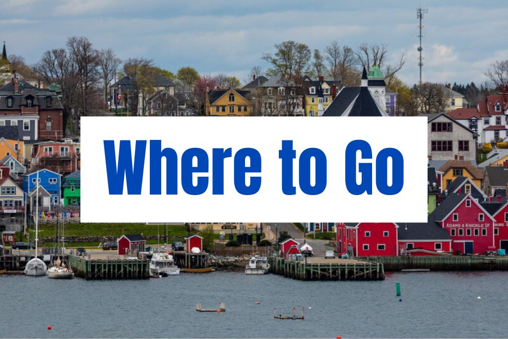 "Where to Go" appears in large blue text over a colorful waterfront town with fishing boats and bright houses. The scene introduces popular places to visit across Nova Scotia.